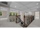 Upstairs landing area featuring decorative iron railings and coffered ceilings at 7409 Chesley Ln, Durham, NC 27713
