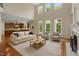 Inviting living room with high ceilings, a fireplace, and a wall of windows, perfect for entertaining and relaxation at 7409 Chesley Ln, Durham, NC 27713