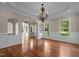 Bright and open living space with shiny hardwood floors, large windows, and elegant wainscoting at 7409 Chesley Ln, Durham, NC 27713