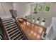Open-concept living room with high ceilings, fireplace, and staircase at 7409 Chesley Ln, Durham, NC 27713