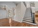 Elegant staircase with dark wood treads and decorative iron railing, leading to the upper level at 7409 Chesley Ln, Durham, NC 27713