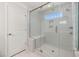 Glass walk-in shower boasts natural light, gray tile, a built-in seat, and shower and rain shower heads at 750 Bachelor Gulch Way, Apex, NC 27523