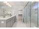 Bathroom featuring dual vanity, walk-in glass shower, and closet with an abundance of natural light at 750 Bachelor Gulch Way, Apex, NC 27523