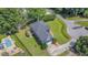 Aerial shot of property highlights large, well-maintained yard, back deck, and pool at 104 Goldleaf Ct, Angier, NC 27501