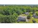 Aerial view of a two-story home nestled in a mature landscape with green trees surrounding the neighborhood at 104 Goldleaf Ct, Angier, NC 27501