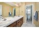 Bright bathroom featuring a double sink vanity and a separate toilet area at 104 Goldleaf Ct, Angier, NC 27501