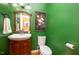Stylish half bathroom featuring a wood vanity, and green walls at 104 Goldleaf Ct, Angier, NC 27501