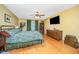Bedroom featuring hardwood floors, ceiling fan, and mounted television at 104 Goldleaf Ct, Angier, NC 27501