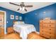 Comfortable bedroom with hardwood floors, blue painted walls, and natural light at 104 Goldleaf Ct, Angier, NC 27501
