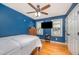 Cozy bedroom with a flat screen television, hardwood floors, and a ceiling fan at 104 Goldleaf Ct, Angier, NC 27501