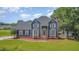Lovely home with manicured lawn, brick accents, and inviting front porch at 104 Goldleaf Ct, Angier, NC 27501