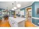 Bright kitchen with white cabinets, stainless steel appliances, and a view into the dining area at 104 Goldleaf Ct, Angier, NC 27501