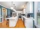 Well-lit kitchen with white cabinetry, stainless steel appliances, and an island at 104 Goldleaf Ct, Angier, NC 27501