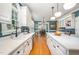 Spacious kitchen featuring white cabinetry, stainless steel appliances, and a large island at 104 Goldleaf Ct, Angier, NC 27501