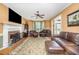 Spacious living room features a fireplace, hardwood floors, and comfortable leather furniture at 104 Goldleaf Ct, Angier, NC 27501