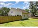 Fenced backyard with a lush lawn, offering privacy and a charming pergola area at 105 Rolling Stone Ct, Sanford, NC 27332