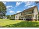 Expansive backyard featuring a patio, well-maintained lawn, and a traditional two-story house exterior at 105 Rolling Stone Ct, Sanford, NC 27332