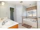 Spacious bathroom features double sinks, bathtub, and large window at 105 Rolling Stone Ct, Sanford, NC 27332