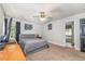 Bright bedroom with neutral carpet, ceiling fan, en-suite bathroom, and tasteful decor at 105 Rolling Stone Ct, Sanford, NC 27332