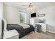 Well-lit bedroom with a cozy bed, vanity area, and modern ceiling fan at 105 Rolling Stone Ct, Sanford, NC 27332