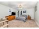 Spacious bedroom featuring neutral carpet, a ceiling fan, and a large dresser with a TV at 105 Rolling Stone Ct, Sanford, NC 27332