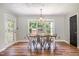 Dining room with a view of the wooded backyard and a metal dining set at 105 Rolling Stone Ct, Sanford, NC 27332