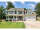 Charming two-story home with a welcoming front porch and well-manicured lawn at 105 Rolling Stone Ct, Sanford, NC 27332