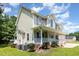 Two-story home with covered porch, manicured bushes and a two-car garage at 105 Rolling Stone Ct, Sanford, NC 27332