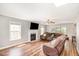 Living room features a fireplace, large sectional couch and hard wood floors at 105 Rolling Stone Ct, Sanford, NC 27332