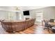Living room with fireplace, desk, large sectional and hardwood floors at 105 Rolling Stone Ct, Sanford, NC 27332