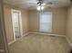 Cozy bedroom with carpet flooring, a ceiling fan, and a bright window at 108 Herbert St, Durham, NC 27703