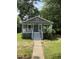 Charming single-story home with a gray exterior, inviting front porch, and mature trees at 108 Herbert St, Durham, NC 27703