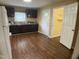 Spacious kitchen features wood flooring, black cabinets, and white appliances at 108 Herbert St, Durham, NC 27703