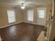Light-filled living room with wood floors, ceiling fan, and an inviting fireplace at 108 Herbert St, Durham, NC 27703