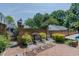 Inviting backyard with brick wall, manicured landscaping, and iron gate providing access to other parts of the yard at 1110 Edgewood Ave, Burlington, NC 27215