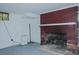 Vintage brick fireplace in a spacious basement with white painted walls and a small window at 1110 Edgewood Ave, Burlington, NC 27215