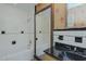 Bathroom displaying a built-in tub, black countertops, and vintage-inspired wallpaper at 1110 Edgewood Ave, Burlington, NC 27215