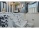 Bathroom with black and white striped wallpaper and white fixtures at 1110 Edgewood Ave, Burlington, NC 27215