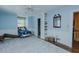 Comfortable blue bedroom featuring a bed, built-in shelves, and a decorative mirror at 1110 Edgewood Ave, Burlington, NC 27215