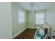Serene bedroom with light green walls, hardwood floors, and ample natural light from two windows at 1110 Edgewood Ave, Burlington, NC 27215