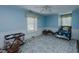 Charming bedroom with blue walls, carpet, two windows, and ample space for relaxation and play at 1110 Edgewood Ave, Burlington, NC 27215