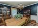 Formal dining room with dark walls, wood furnishings, and a decorative chandelier at 1110 Edgewood Ave, Burlington, NC 27215