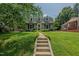 Inviting front yard with a stone walkway leading to the house at 1110 Edgewood Ave, Burlington, NC 27215