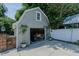 Detached garage with a gable roof and open door with visible storage at 1110 Edgewood Ave, Burlington, NC 27215