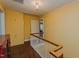 Hallway landing featuring hardwood floors and yellow painted walls at 1110 Edgewood Ave, Burlington, NC 27215