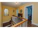 Upstairs hallway with hardwood floors and yellow walls at 1110 Edgewood Ave, Burlington, NC 27215