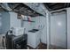 Basement laundry area with a washer, dryer, and basic laundry supplies at 1110 Edgewood Ave, Burlington, NC 27215