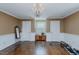 Living room with hardwood floors, traditional chest, a leaning mirror, and natural light from a window at 1110 Edgewood Ave, Burlington, NC 27215