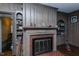 Cozy living room features a brick fireplace, wood-paneled walls, and built-in shelving at 1110 Edgewood Ave, Burlington, NC 27215