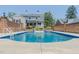 Beautiful backyard pool area with surrounding brick fence, patio, and lush landscaping for ultimate relaxation at 1110 Edgewood Ave, Burlington, NC 27215